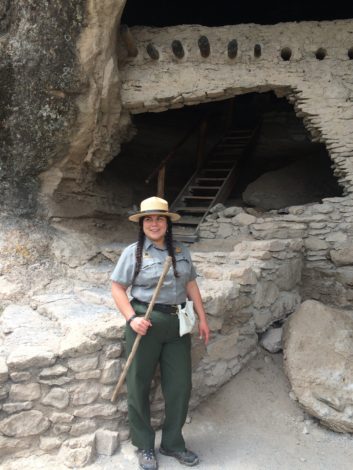 Park Ranger DeAnn Casimiro stands in front of ruins.