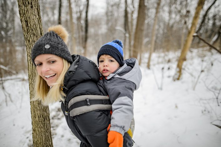 mom with child in carrier on a winter hike