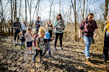 group of parents and young children hiking