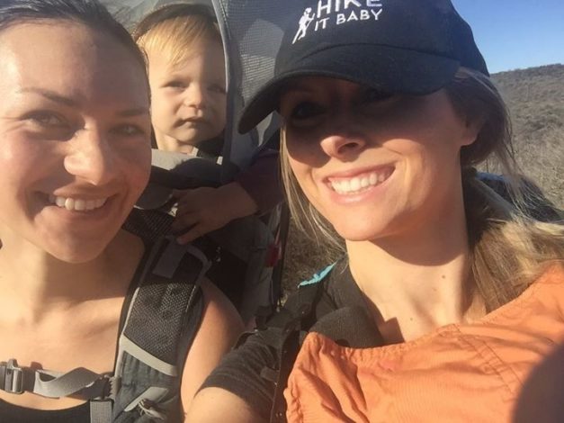 Hiking with a Hearing Loss by Vanessa Wright for Hike it Baby (image of two moms hiking with their kids in carriers)