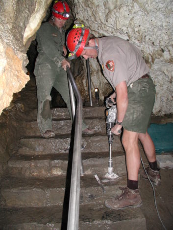 Recreation Specialist Interview with Jon Jasper by Maggie Fram for Hike it Baby: Jon Jasper uses a drill inside a cave.