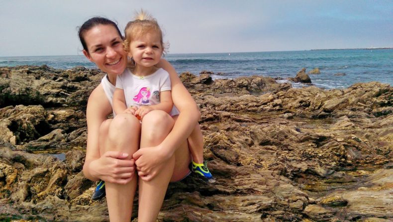 Hiking with a Hearing Loss by Vanessa Wright for Hike it Baby (mom and daughter on a rocky coast line by an ocean)