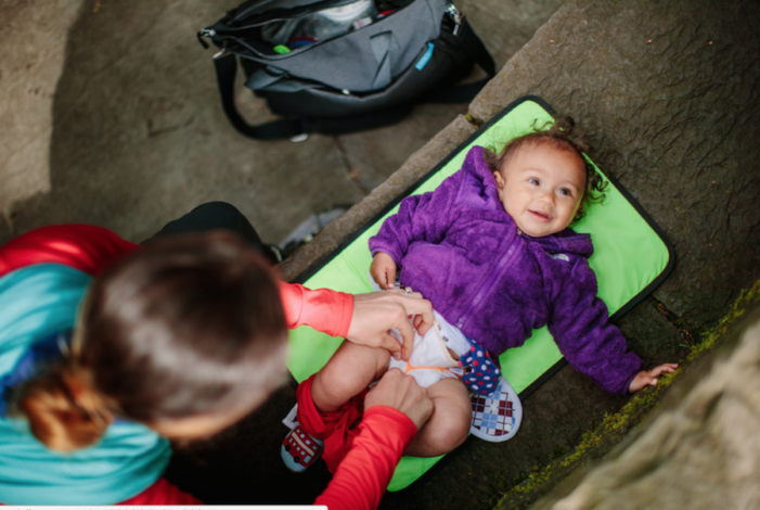 Cloth Diapering while Hiking by Andrea Zimmer for Hike it Baby (image of a baby getting a cloth diaper change) 