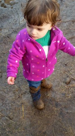 Young girl with muddy boots and jeans