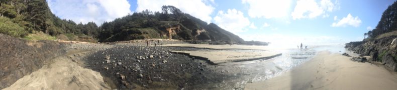 Panorama of Oahu beach and mud with blue sky and white to dark black beach