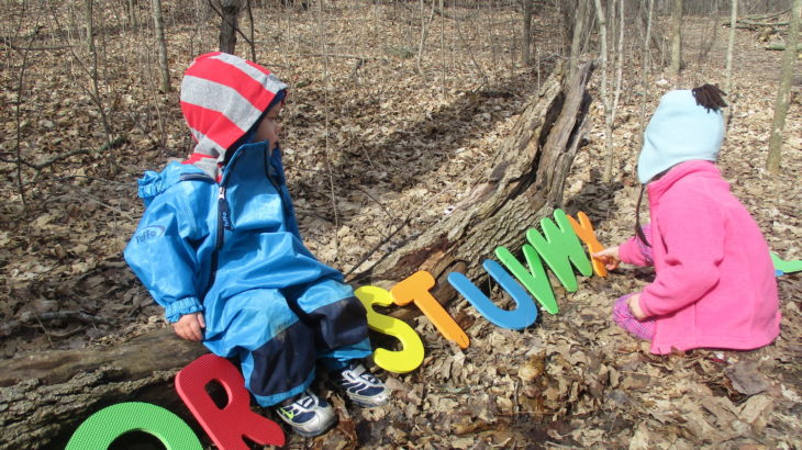 A is for Alphabet Themed Hikes by Moriah Butler for Hike it Baby (image of 2 kids playing with large foam letters along a trail)