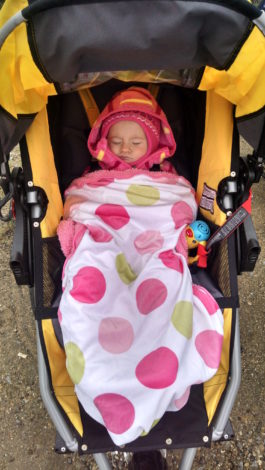baby bundled up for winter weather in a jogging stroller