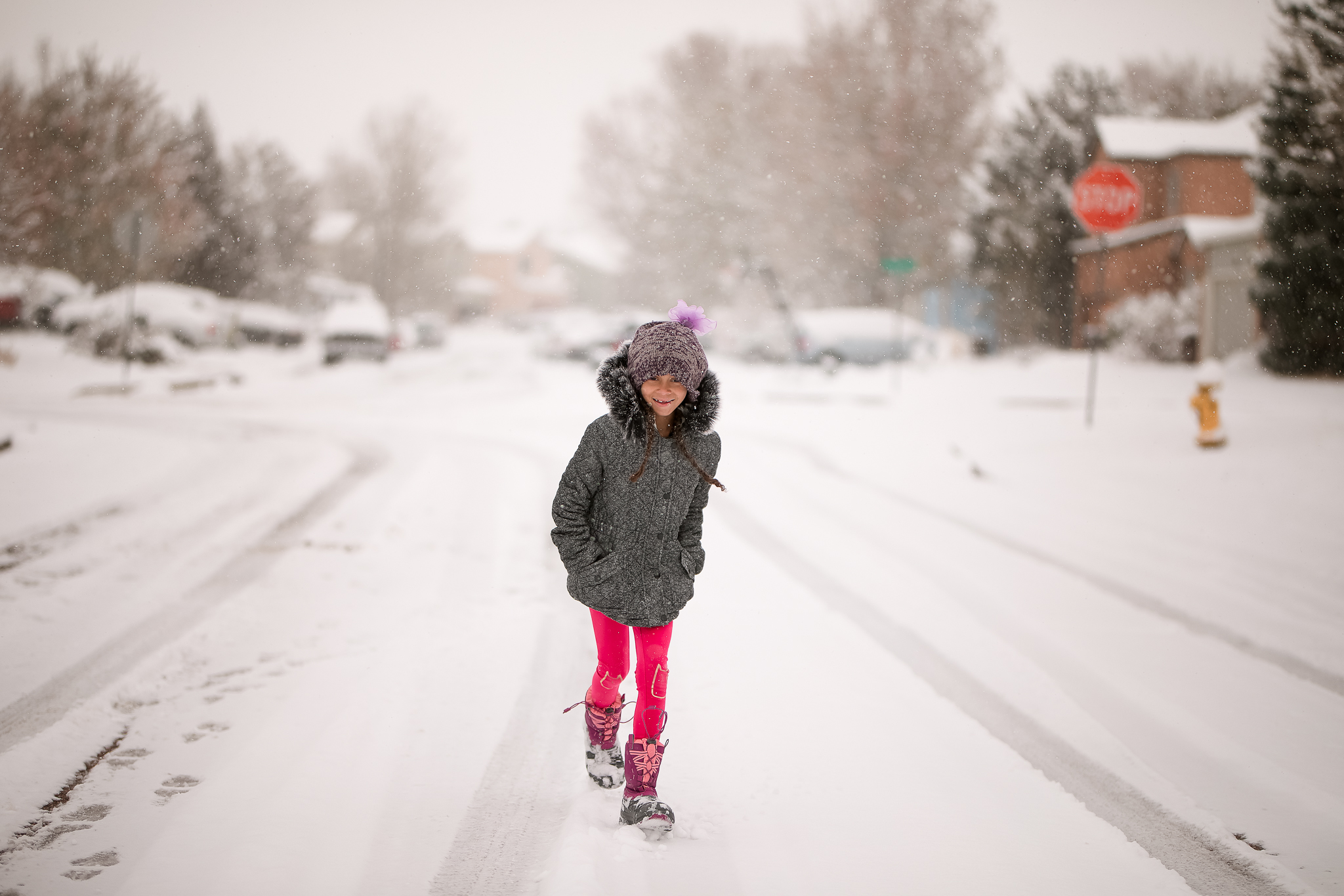 girl walking down a snowy neighborhood street