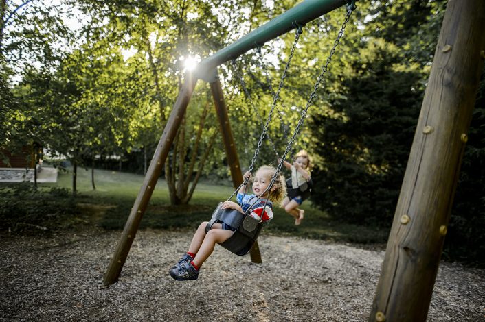 girls playing on a swingset
