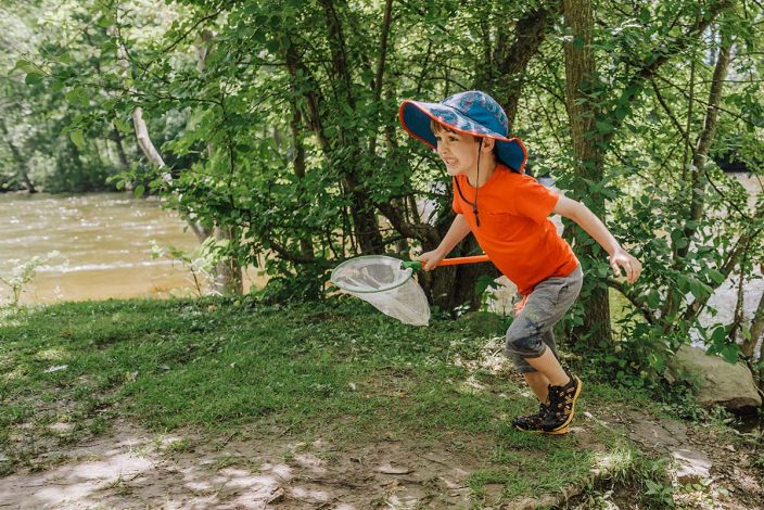 boy running with bug net
