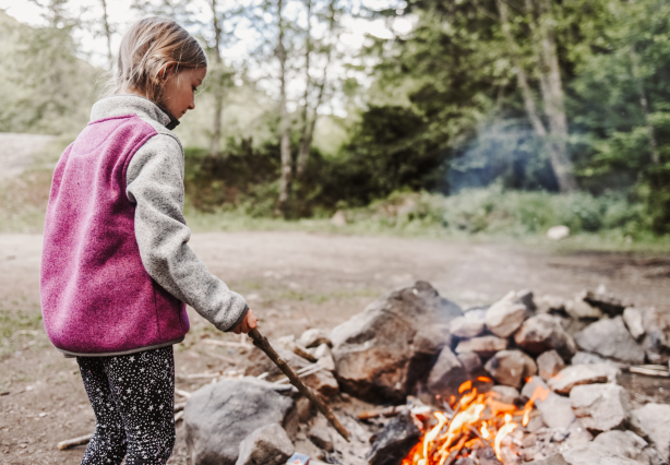 child watching campfire in a ring