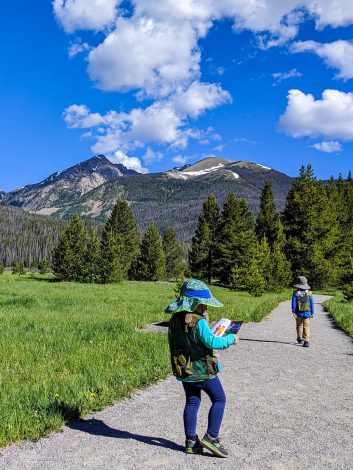 kids in rocky mountain national park with junior ranger booklets