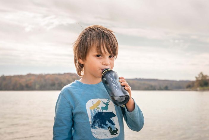 boy using a water filter bottle for hydration