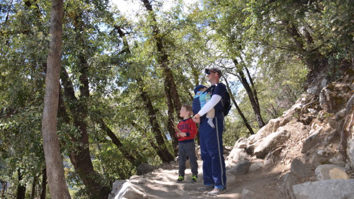 Tay-Sachs and Hike for Grayson by Felicia W for Hike it Baby (Image of dad carrying son while hiking with second son on a dirt trail)