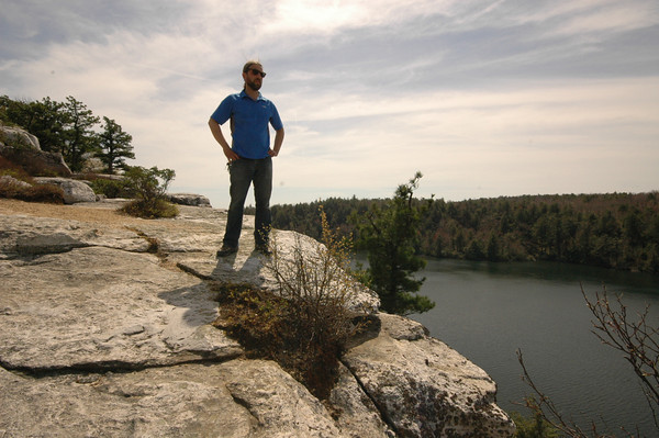 Man standing on rocks high above the lake at Minnewaska Park