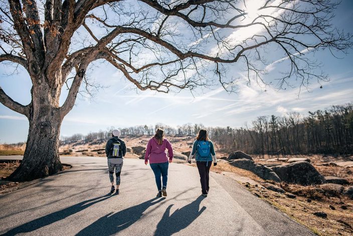 women walking down a path