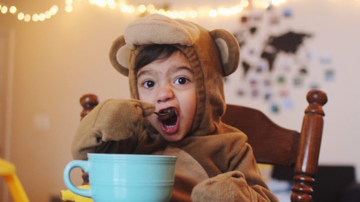 child wearing costume eating