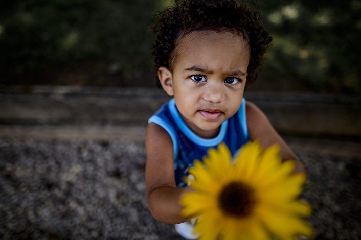 boy holding flower