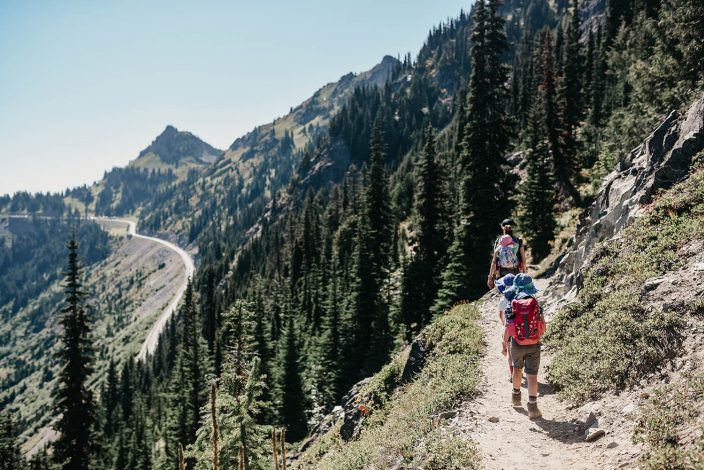 woman with kids hiking in the mountains