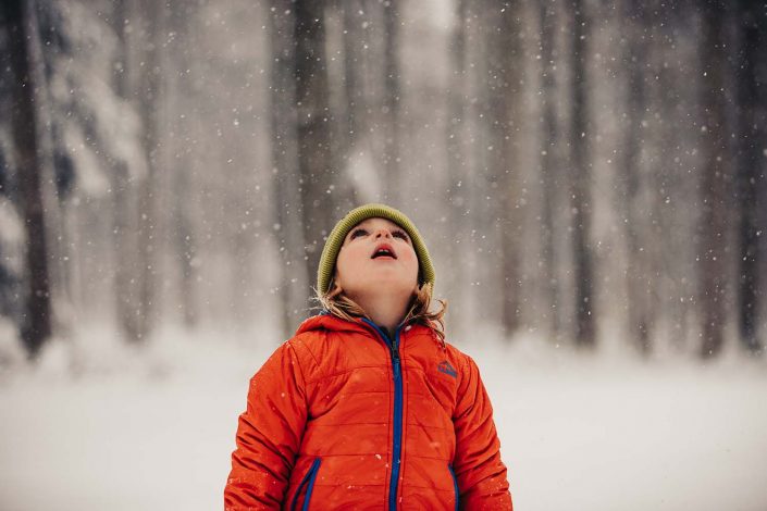 kid enjoying the falling snow