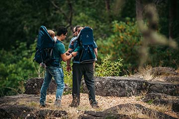 dad and child on a hike using a child carrier